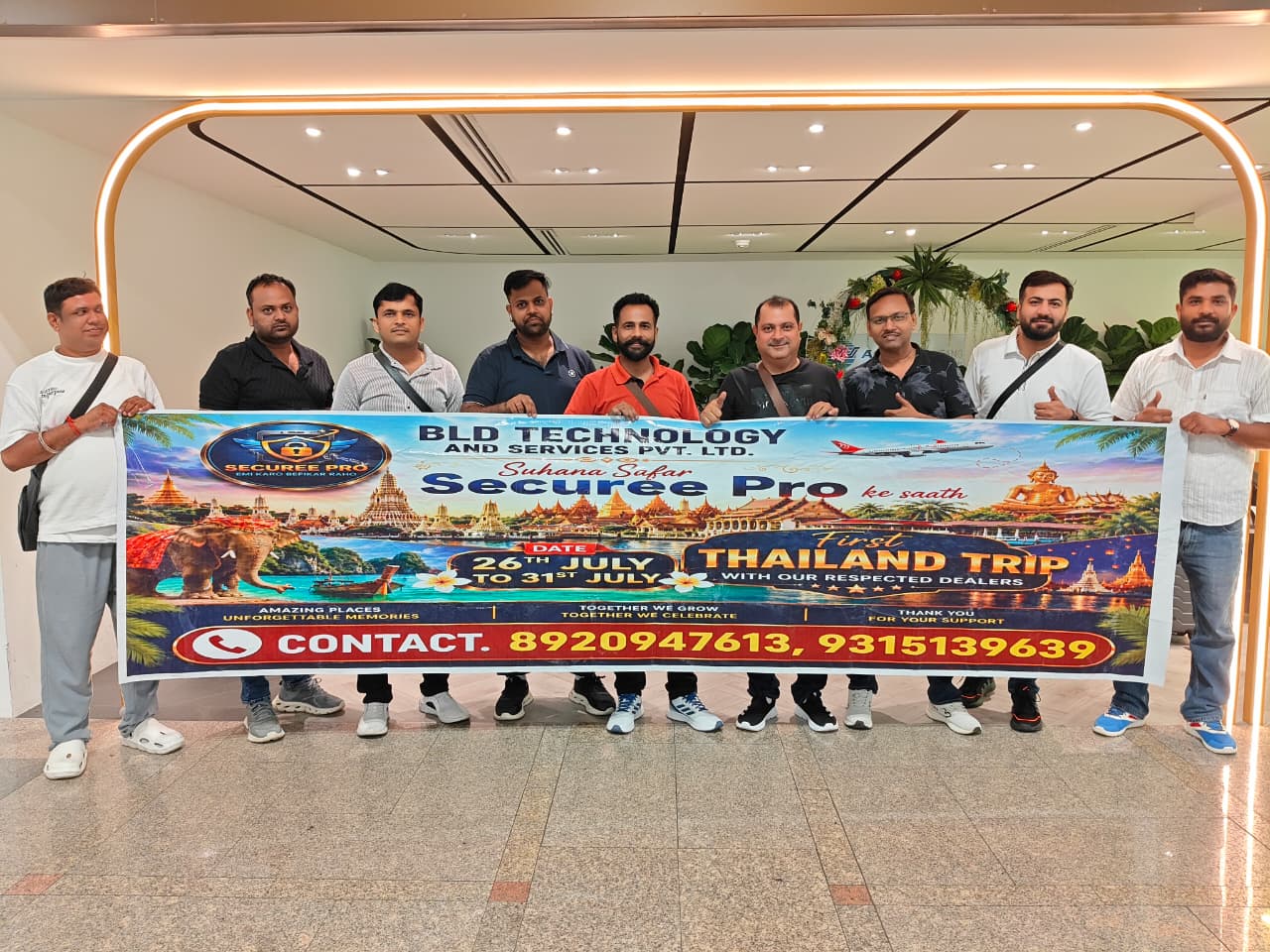 BLD Technology team with Securee Pro dealers holding a banner at the airport, celebrating the first Thailand achievers trip